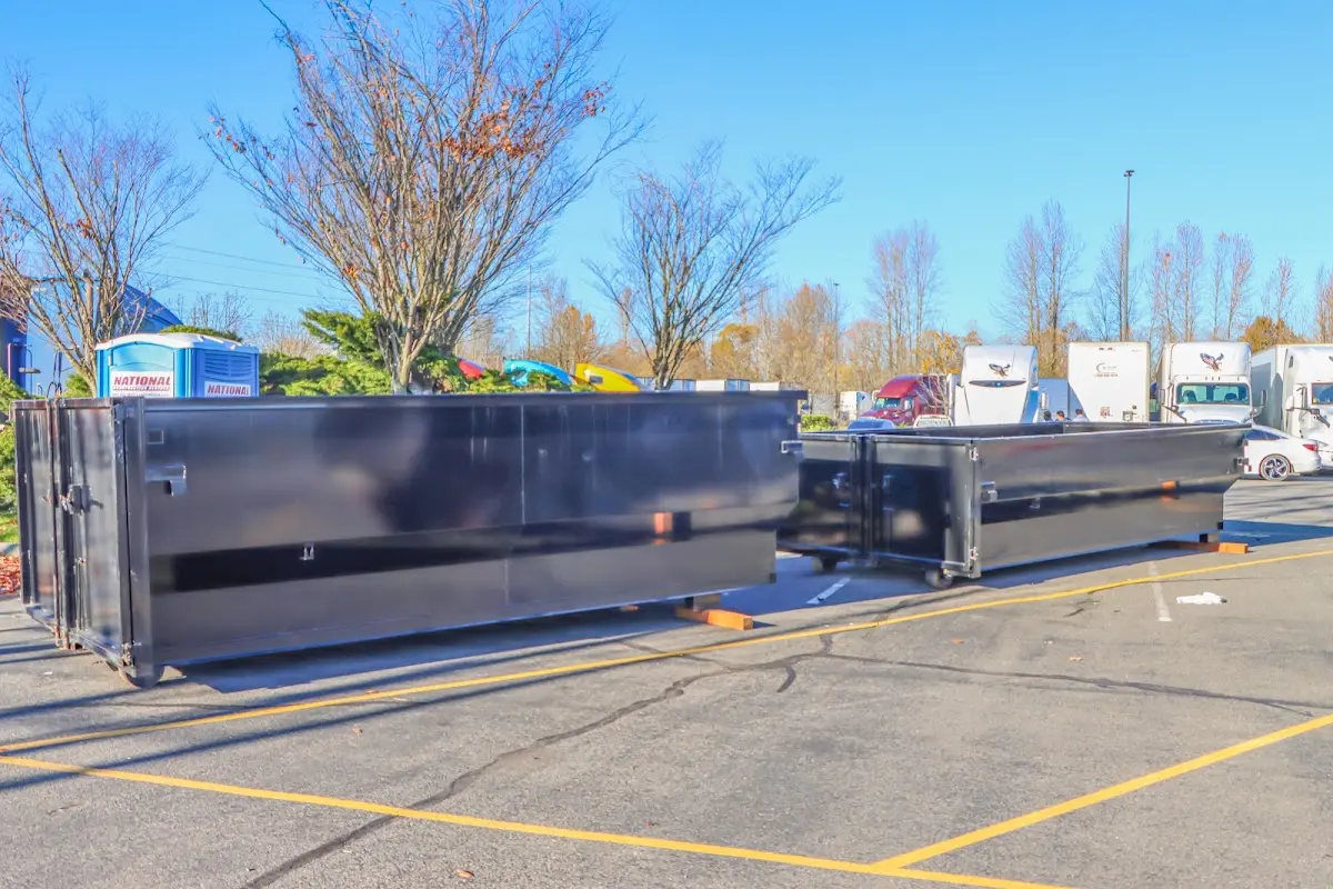 Professional dumpster rental service with roll-off container on residential driveway in Fairview Heights